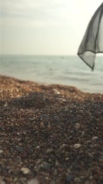 Güneşli bir günde, siyah bir mayo giymiş ve pareo akan bir kadın bacağı.. 