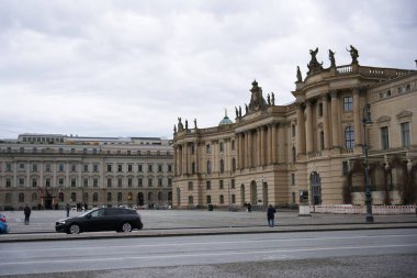 Berlin, Almanya 02.13.2025 Humboldt Üniversitesi 'nin büyük neoklasik binası. Süslü heykeller, sütunlar ve bulutlu bir gökyüzü altında kubbeli bir çatı.. 