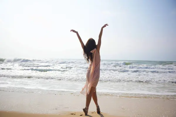 Dalgalı pembe bir elbise içinde sörf tahtasının üzerinde duran bir balerin, doğanın ham enerjisiyle kusursuz bir görsel denge içinde hassas insan zerafeti hareketi, dinginliği ve güzelliğiyle çelişir.. 