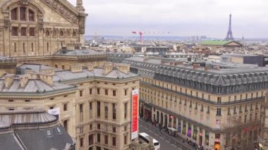 Paris, Fransa 02.20.2025 Paris ufuk çizgisi ve Eyfel Kulesi 'nin geniş açılı manzarası bulutlu bir günde Galeries Lafayette' in terasından görüldü..