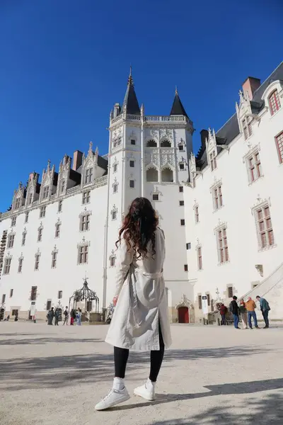 Chateau des Ducs de Bretagne Nantes Fransa 'da trençkot giyen kadın.