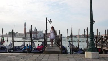 San Giorgio Maggiore Venedik 'le rıhtımdaki yazlık elbiseli turist.