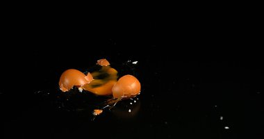 Siyah arkaplanda yumurta düşüşü ve patlaması