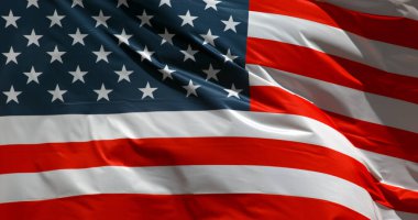 Mavi gökyüzünde dalgalanan Amerikan bayrağı