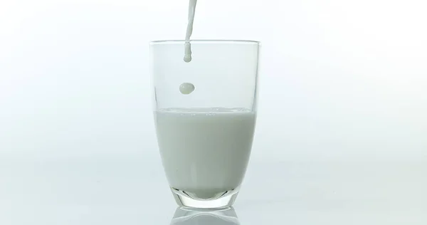 Молоко Наливают Стакан Белом Фоне — стоковое фото
