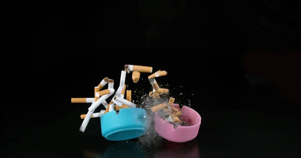 Ashtrays Cigarettes Falling Black Background — Stock Photo, Image