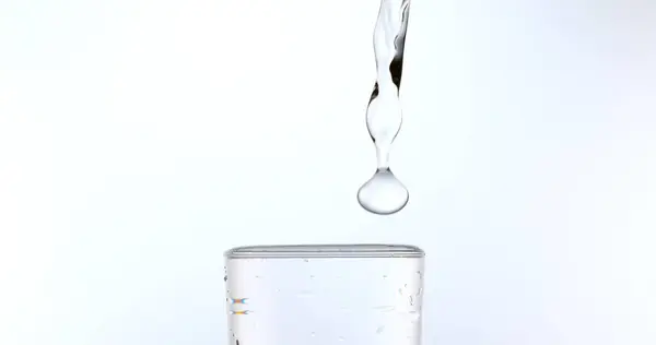 Water Being Poured Glass White Background — Stock Photo, Image