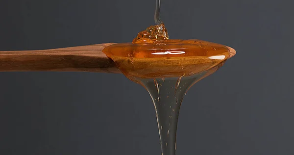 Honey Flowing Spoon Black Background — Stok Foto