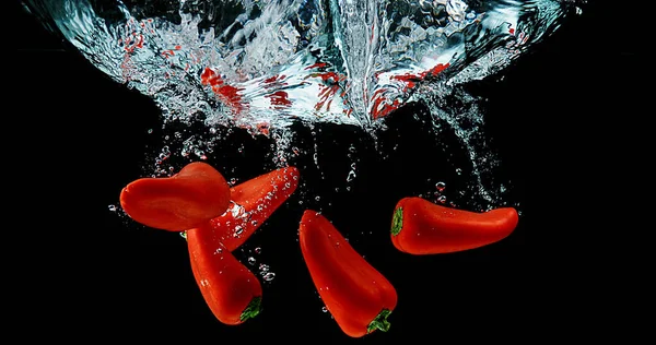 Red Sweet Peppers Capsicum Annuum Vegetable Falling Water Black Background — Stock Photo, Image