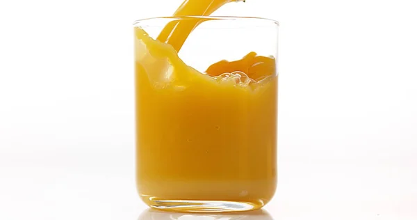 Orangensaft Wird Vor Weißem Hintergrund Ins Glas Gegossen — Stockfoto