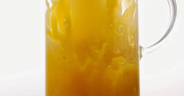 Orange Juice Wordt Gegoten Glas Tegen Witte Achtergrond — Stockfoto