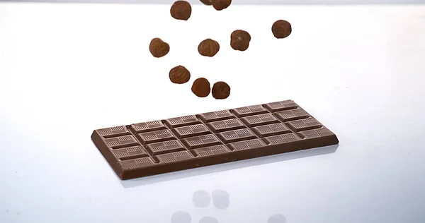 Hazelnuts Falling Milk Chocolate Tablet — Stock Photo, Image