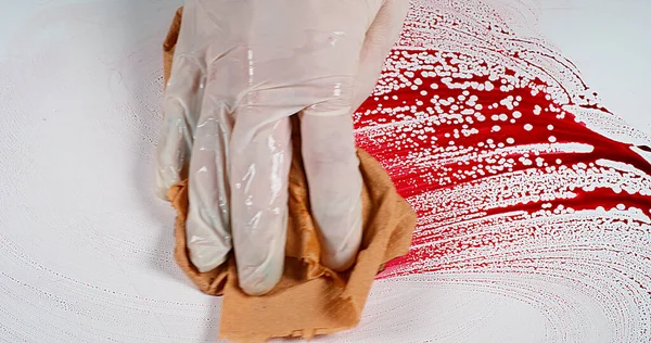 Gloved hand that wipes blood against White Background