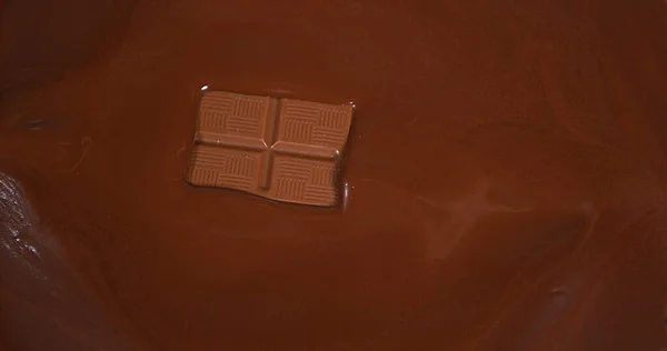 Chocolate tablet falling into Milk Chocolate