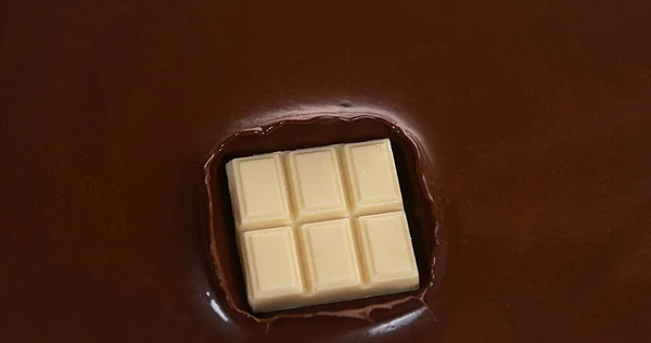White Chocolate Tablet falling into Milk Chocolate