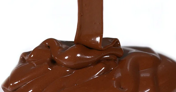 Chocolate Flowing on White Background