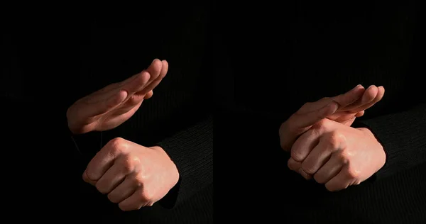 ブラックバックグラウンドに対するサインを作る女性の手 ロイヤリティフリーのストック画像