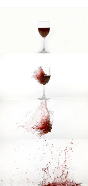 ホワイトバックグラウンドに対する赤ワインの破損と分割のガラス ロイヤリティフリーのストック写真