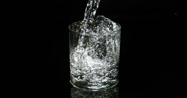Water Being Poured Glass Black Background — Stock Photo, Image