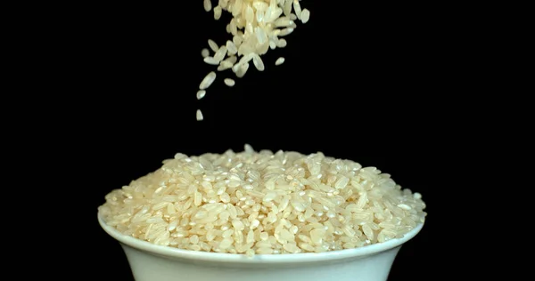 Rýže Dopadající Černé Pozadí — Stock fotografie