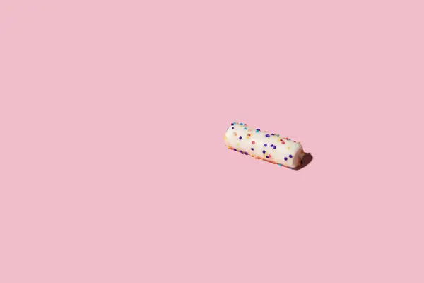 stock image One piece of candy over pink background
