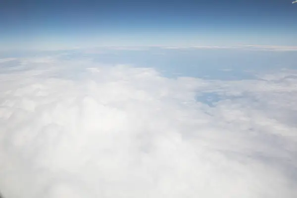 stock image Expansive Cloudscape Seen from Above in a Clear Blue Sky