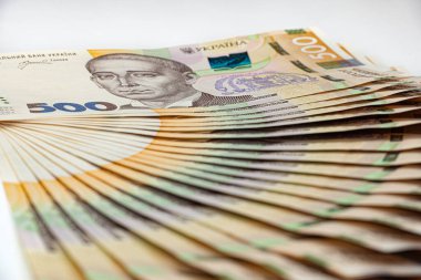 Ukrainian 500 hryvnia paper banknotes fanning on a white background.