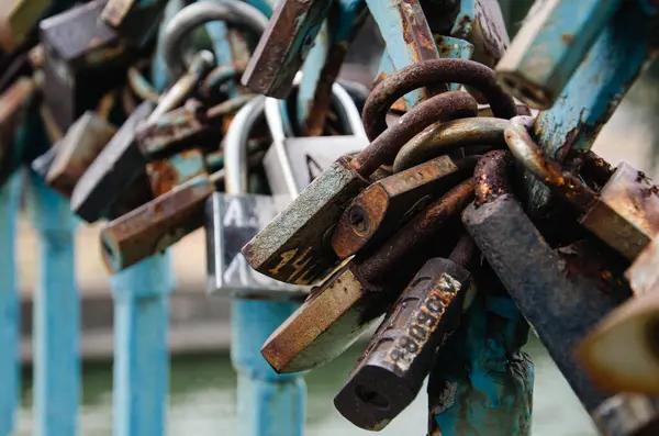 stock image Love locks traditionally hung on the bridge by lovers and newlyweds, close-up.