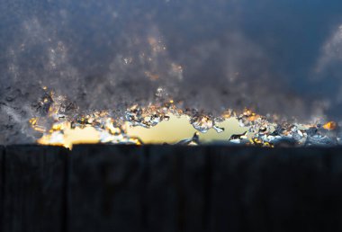 Winter-spring landscape, thaw on the background of sunset.