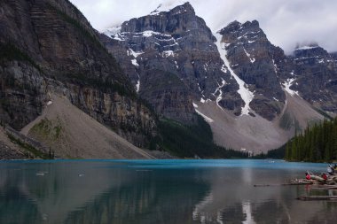 A view of Lake Moraine Canada showing the glacier and the unique coloured water. The water of the lake was so still we were able to get a reflection from the other side clipart