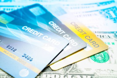 Credit card model on US dollar banknotes, finance and business.