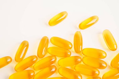 Fish oil or Cod liver oil gel in capsules with omega 3 vitamins, supplementary healthy food.