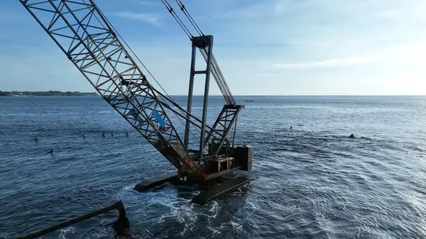 Endonezya sahilinde sörfçülerle birlikte terk edilmiş Crane.