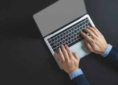 Bir iş adamı dizüstü bilgisayarı açar ve bir proje üzerinde çalışır.