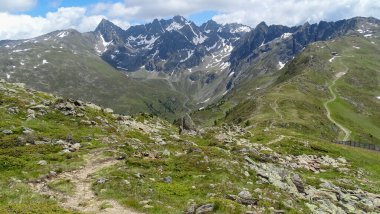 Mountain hiking through the austrian Alps. A colored Alps view - white, blue, green, grey, brown.