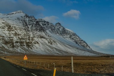 Kemerdeki parlak mavi gökyüzüne karşı karla kaplı dağ zirvesi