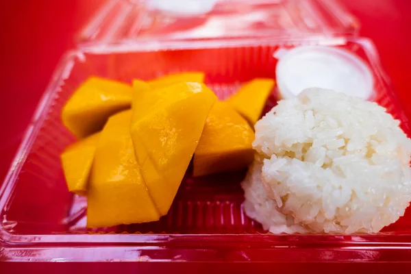 Mango sticky rice, a photo of fresh mango and sticky rice on market table. Mango sticky rice is a traditional Southeast Asian and South Asian dessert