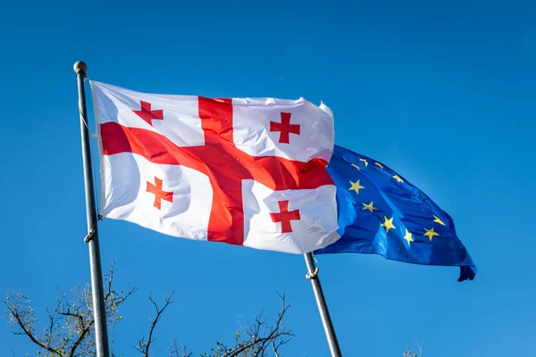 Georgia flag and EU flag. Flag of the country Georgia and European union together