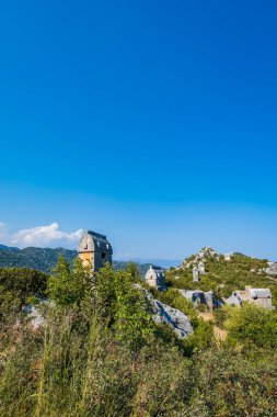 Simena (Kalekoy) ancient ruin site with sarcophagus by historic Simena castle, Turkey by Kekova islands.