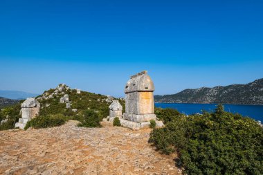 Simena (Kalekoy) ancient ruin site with sarcophagus by historic Simena castle, Turkey by Kekova islands.
