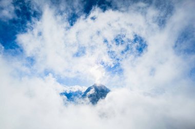 Sabah, Endonezya, Lombok 'taki Rinjani Dağı' nda bulutlarla kaplı bir dağ zirvesi. Atmosferik dağ fotoğrafı macera, yürüyüş, dağcılık konsepti