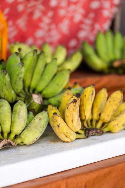 small Thai bananas, green and yellow fresh bananas at market. Pisang Awak bananas in Thailand