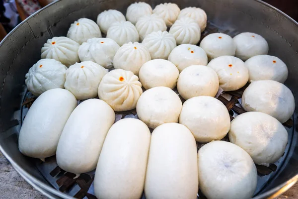 Chinese steamed buns in the steam pot displayed at the stall. Popular street food in Thailand, China, Asia
