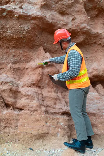Jeologlar uçurum kenarındaki toprağın boyutunu ölçmek için mezura kullanırlar.