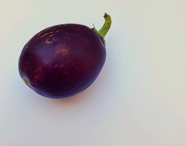 Purple brinjal or eggplant on a white background. This is considered a tasty food which can be used in different dishes across the world clipart