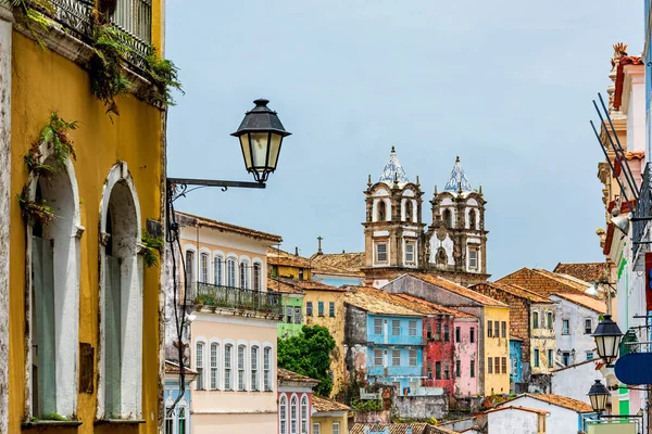 Colorful historical colonial houses facades and antique church tower in baroque and colonial style in the famous Pelourinho district of Salvador, Bahia