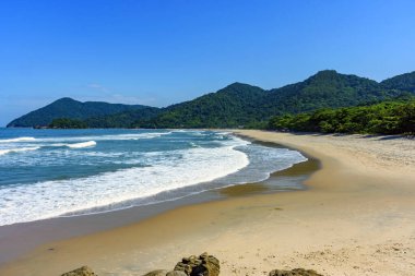 Beach in Bertioga on the north coast of the state of Sao Paulo surrounded by untouched forest and mountains 