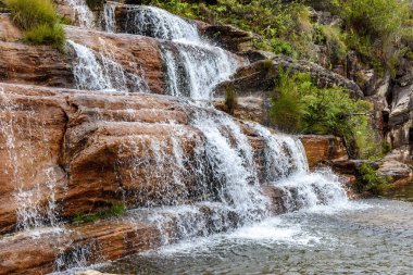 Small waterfall over the rocks and among the vegetation of the Biribiri park in Diamantina, Minas Gerais