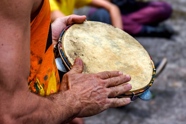 Hands playing tambourine in a street performance in Brazil