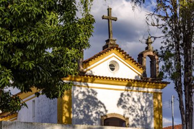 18. yüzyılın başlarında Ouro Preto şehrindeki bitki örtüsü arasında bir kilise cephesi.